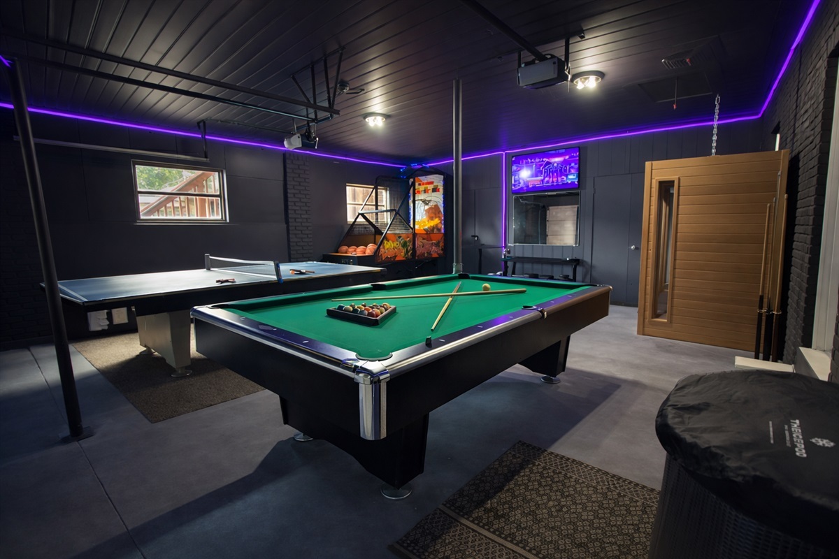 Spacious indoor game room with pool table and ping pong