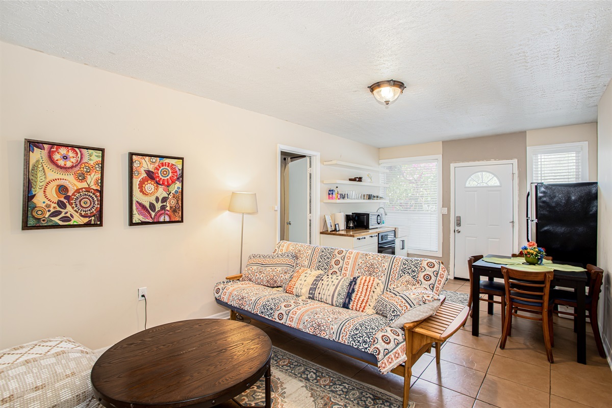 Living room in guest house with futon, sleeps additional two people, smart TV with Roku.