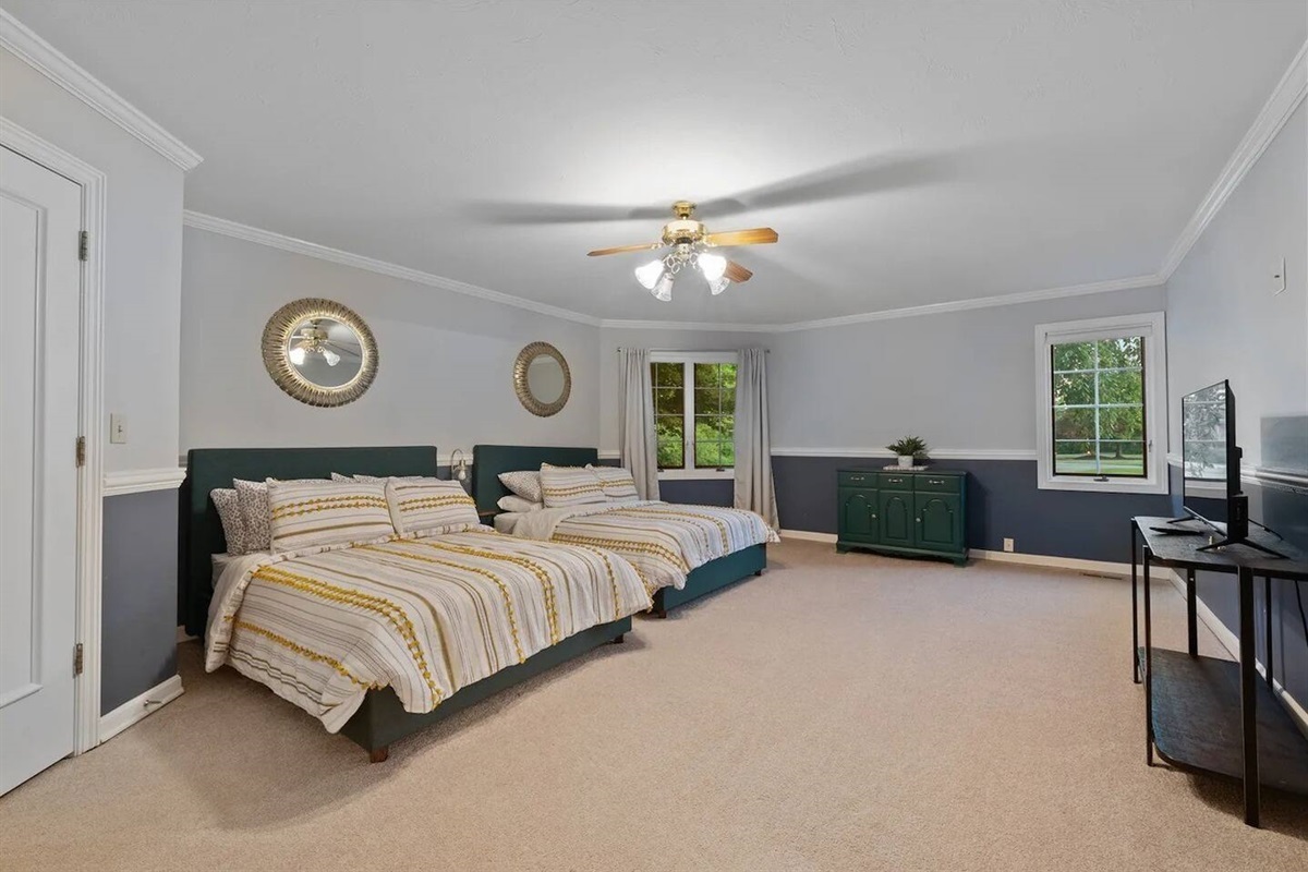 Downstairs guest room w/ 2 queen beds.