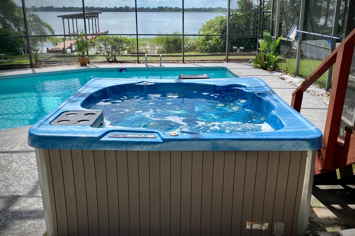 Unwind in the hot tub with stunning lake view.