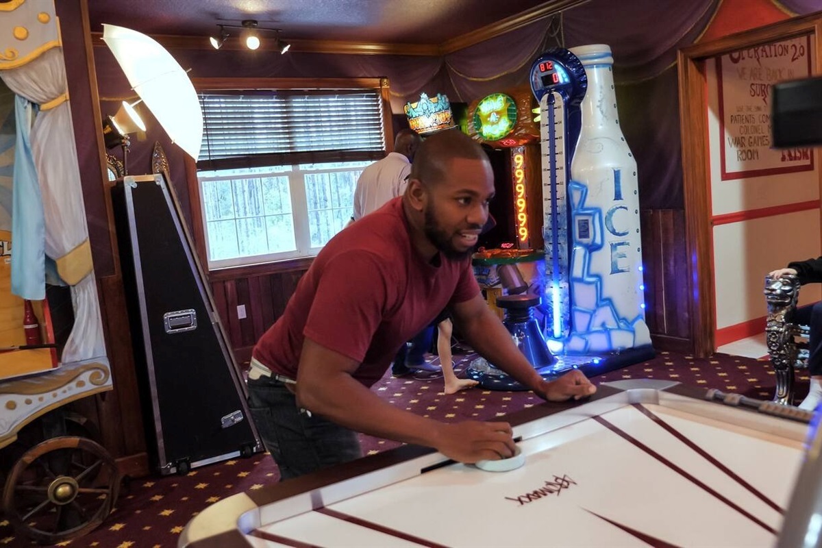 Air hockey battles in the arcade room