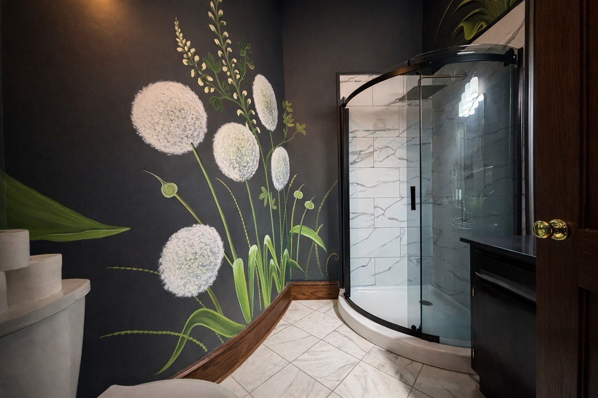Our stylish event bathroom featuring hand painted floral murals.