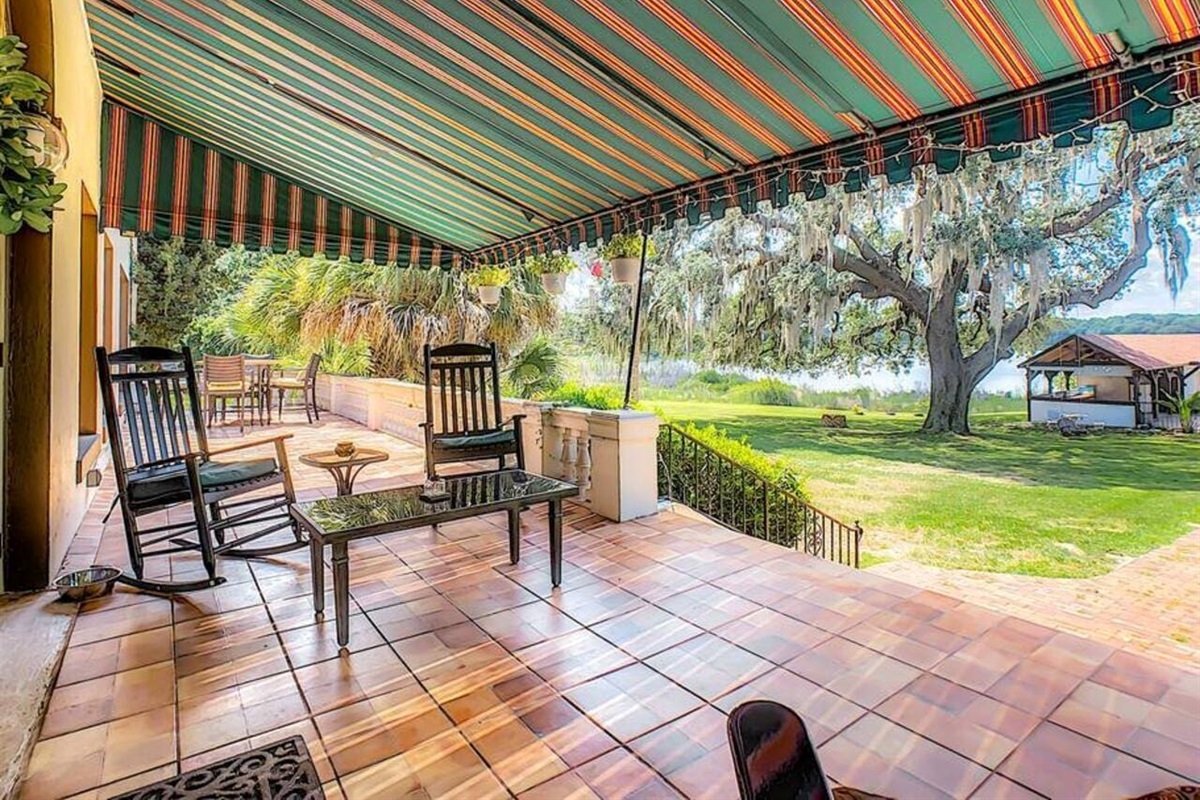 Relax on the covered back patio with lake views, ideal for morning coffee and sunset unwinding.