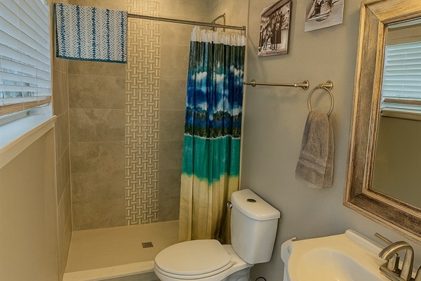 Relax and refresh in this cozy tiled bathroom