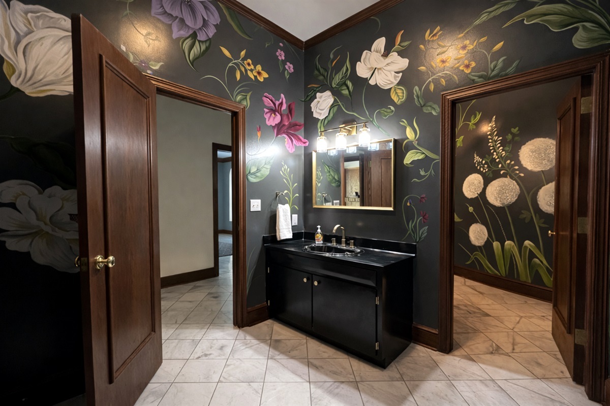 Our stylish event bathroom featuring hand painted floral murals.