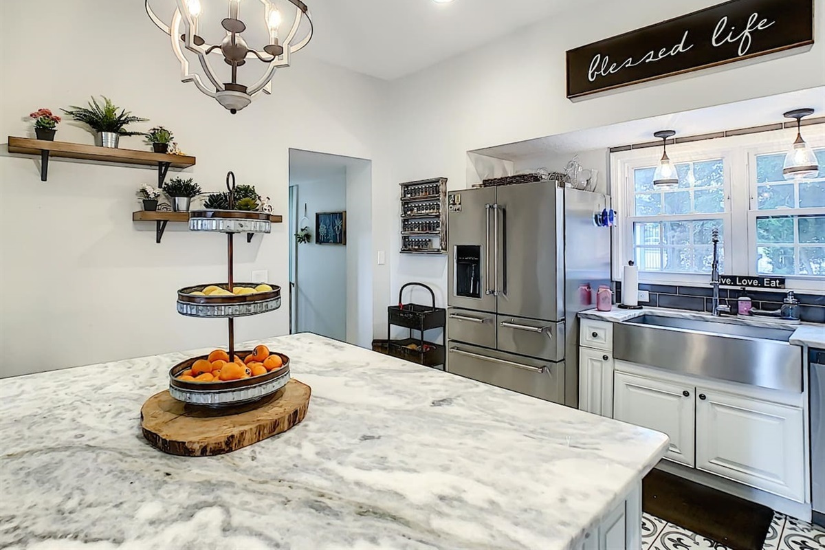Cook and gather in this modern chef kitchen with marble island, ideal for group meals and events.