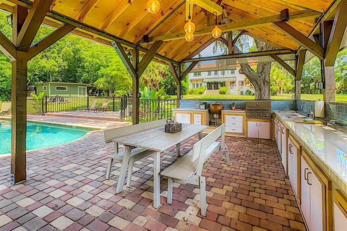 Grill and gather in the outdoor kitchen by the pool, great for family meals and summer nights.