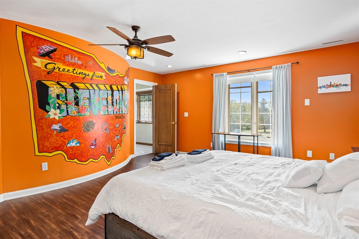 King size bed and custom mural in the "Cleveland Room"