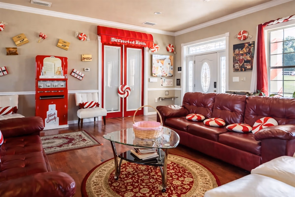 Peppermint Living Room with candy shop door, gumball machine, and peppermint decor at The Sweet Escape