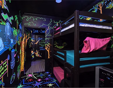 Mini Golf Glow Room bunk beds under UV blacklight mural at Lake Louisa Chateau, Clermont FL