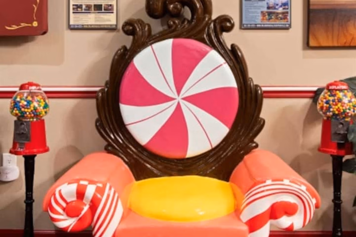 Peppermint-themed chair with candy cushion and gumball machines in Peppermint Living Room at The Sweet Escape