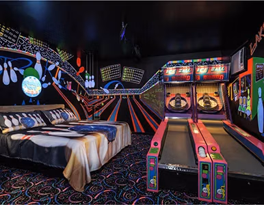 Bedroom with bowling-themed bed and glow-in-the-dark bowling lane at Lake Louisa Chateau