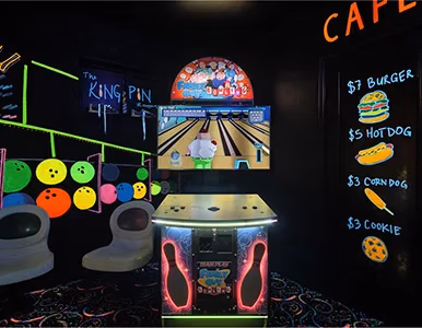 Bowling arcade game and cafe corner with neon decor in Glow-In-The-Dark Bowl Bedroom at Lake Louisa Chateau