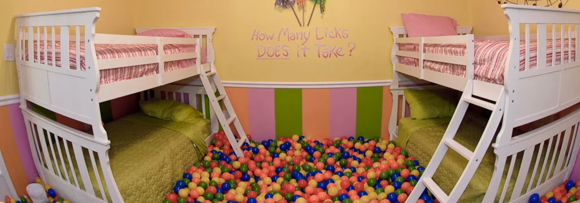 Lollipop Ballpit Bedroom with bunk beds, ball pit, and candy-stripe walls at The Sweet Escape