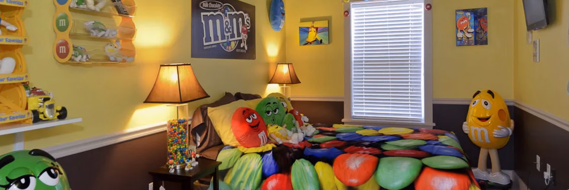 M&M Mania Bedroom with colorful M&M candy bedding and character figures at The Sweet Escape