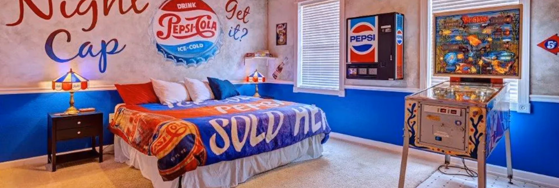 Pepsi Pinball Bedroom with Pepsi wall art, vending machine, and pinball machine at The Sweet Escape