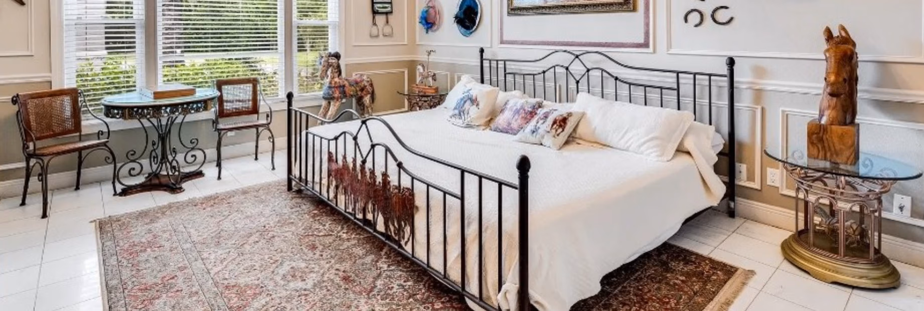 Kentucky Derby-themed bedroom with wrought-iron bed and horse decor at Lake Louisa Chateau