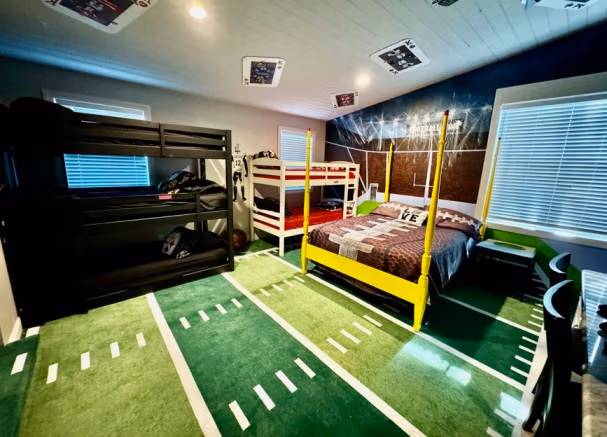 Football-themed bunk beds with goal post and field carpet in Fantasy Football Bedroom at Lake Louisa Chateau