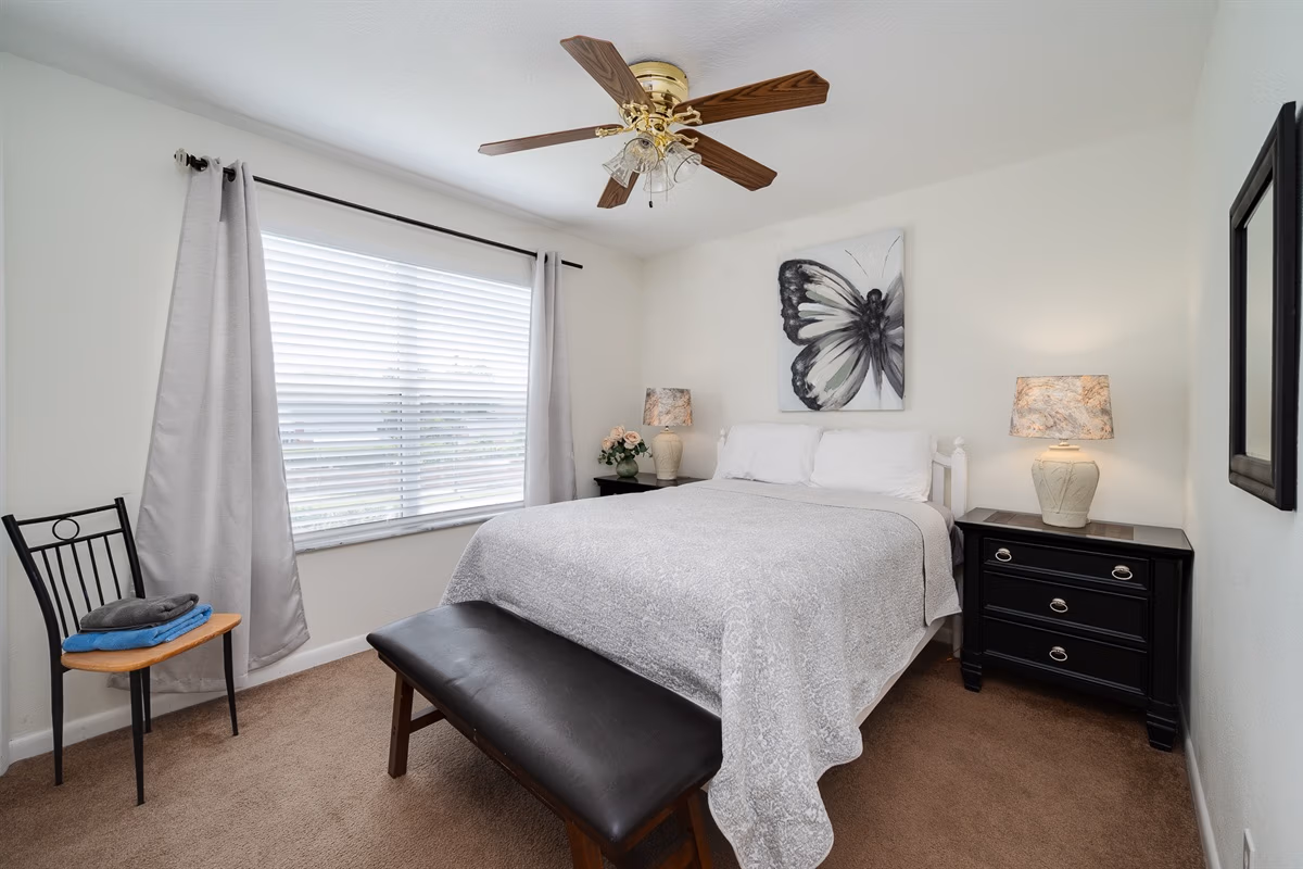 Full bed bedroom with butterfly wall art in Downstairs Tropic Room at Jessamine Dream, Florida