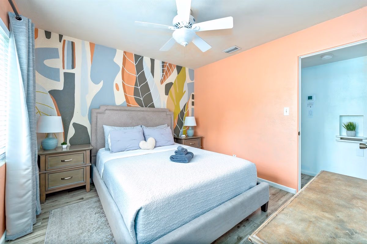 Queen bedroom with abstract tropical mural in Downstairs Tropic Room at Jessamine Dream, Florida